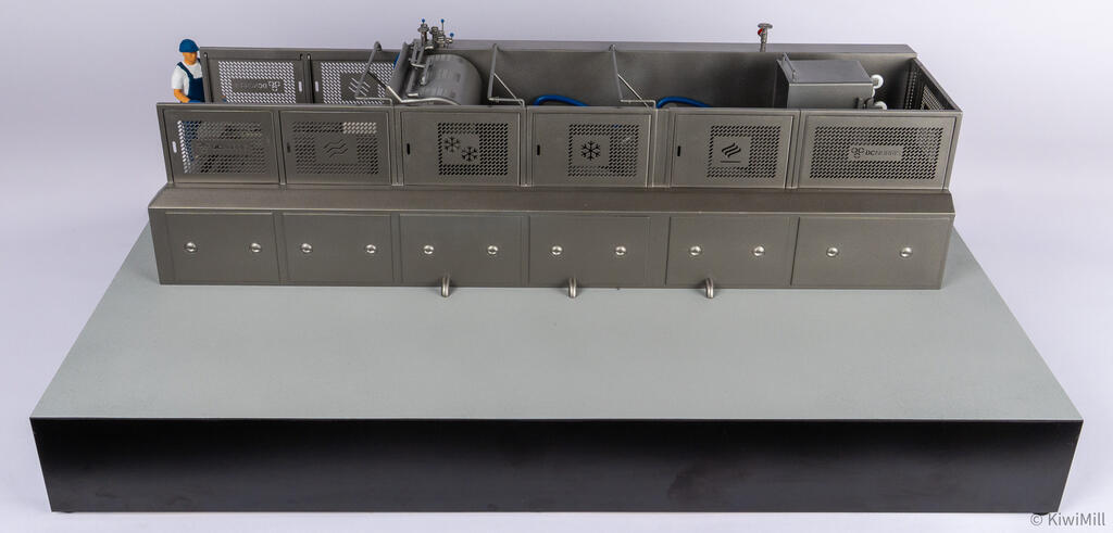 Cooking and chilling line scale model, front view with perforated guard panels in place and a worker figure